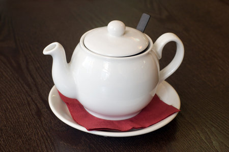 teapot on saucer with red napkinの写真素材