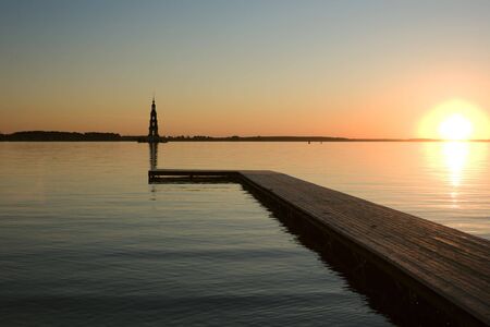 sunset over Volga river, wooden quay at foregroundの写真素材