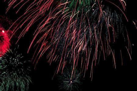 bright colored fiewrork on black night skyの写真素材