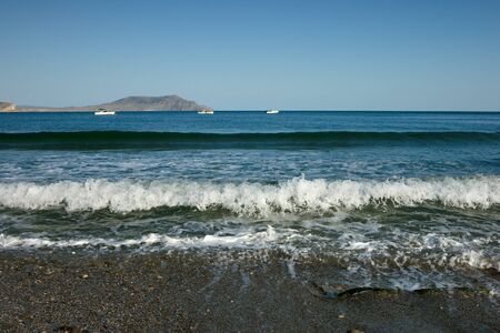 sea surf with far mountains at backgroundの写真素材