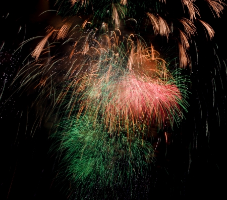 bright colored fiewrork on black night skyの写真素材