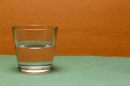 a glass of water on colored backgroundの写真素材