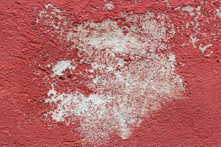 Red old paint on a surface of a stone wallの写真素材
