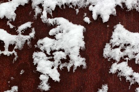snow covering the metal rust surfaces similar to the world map. abstract background.の写真素材