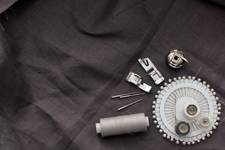 tools and accessories for sewing on a background of linen fabricの写真素材