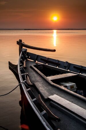 Traditional boat in the lagoon at sunset Valenciaの写真素材