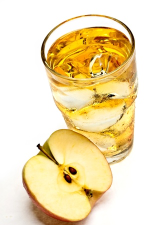 A glass of apple juice with ice cubesの写真素材