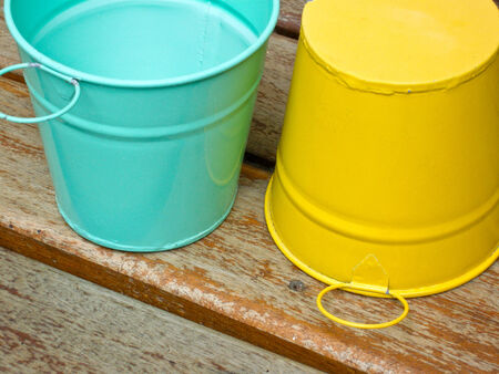 green and yellow metal bucketsの写真素材