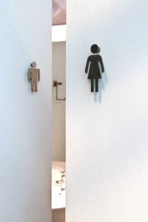 toilet signs on white doors