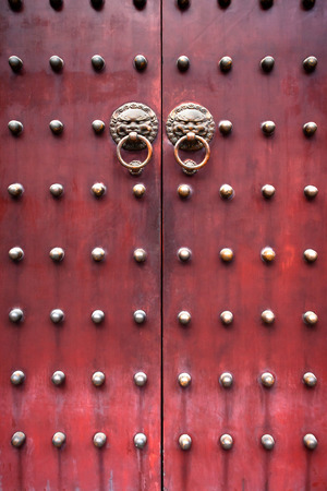 red traditional chinese door with metal knockersの写真素材