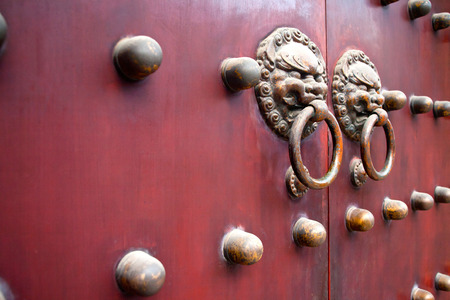 red traditional chinese door with metal knockersの写真素材