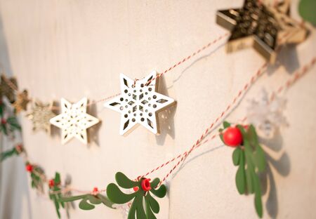 christmas ornaments hang on the wall in the evening lightの写真素材