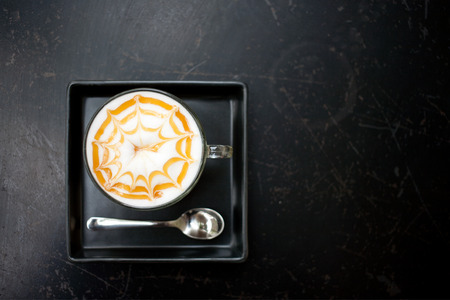 Cup of cappuccino coffee on dark table backgroundの写真素材