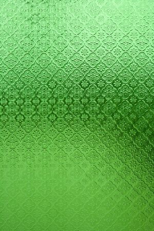 green vintage style window glass with flower patternの写真素材