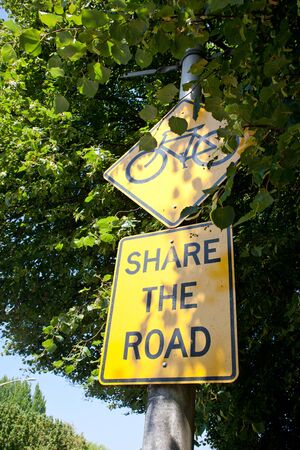 share the road sign on street sideの写真素材