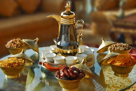 Teapot with dates and sweetsの写真素材