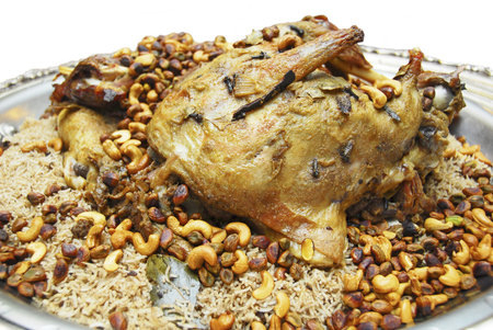 baked lamb ouzi with rice and topped with nutsの写真素材