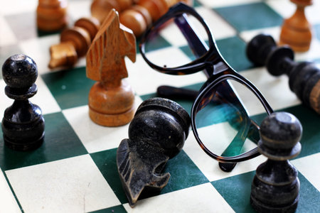 old chess board with chess pieces pilled up togetherの写真素材