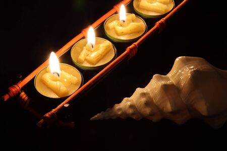 Japan candle with shell on the black backgroundの写真素材