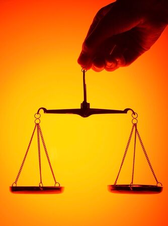 scales on orange light background の写真素材
