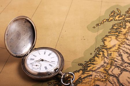 Old silver pocket watch on ancient mapの写真素材