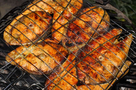 Salmon cooking on grillの写真素材