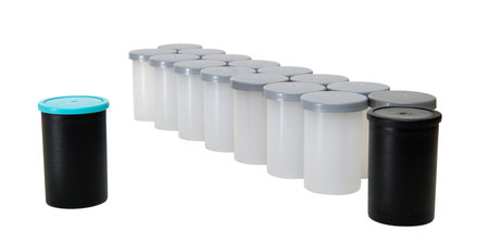 Plastic containers for storing photographic film isolated on a white background