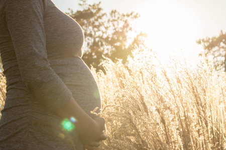 Pregnant expecting woman outdoorsの写真素材