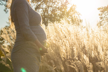 Pregnant expecting woman outdoorsの写真素材