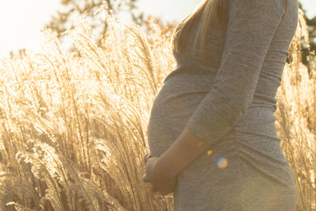 Pregnant expecting woman outdoorsの写真素材