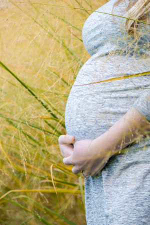 Pregnant expecting woman outdoorsの写真素材