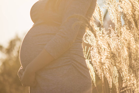 Pregnant expecting woman outdoorsの写真素材