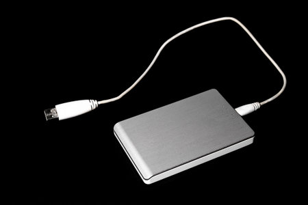 Silver and White External USB Hard Disk Drive against a black backdrop