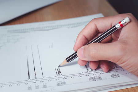 Chemist interpreting proton NMR spectrum, the spectrum of sample analysis by nuclear magnetic...