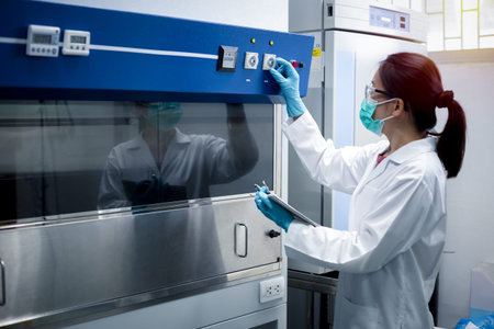 Scientist woman checking the fume hood in the laboratory before and after use for safety in the...