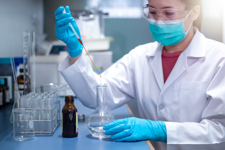 Chemical Advanced Research Laboratory, female scientist is adding reagent for the chemical preparation of the experiment in lab. Research for pharmaceutical, medicine, and biotechnology development.の写真素材