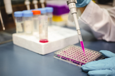 Closeup shot, Scientist use a micropipette with sample preparation for bioassay of in vitro cells on microplate, 96 well in laboratory. Medicinal, Medicine, Biochemistry research.の写真素材