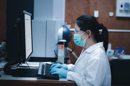 Side view shot, Scientist woman uses mass spectrometry and LC MS for the analysis of samples in the laboratory. Medicinal, Medicine, Pharmaceutical, Chemistry, Biochemistry researcの写真素材