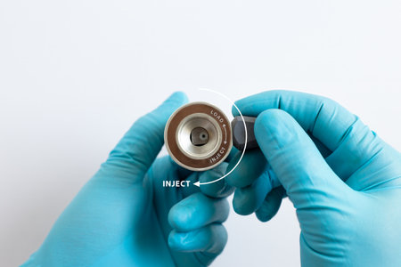 Gloved hands operating a manual HPLC valve, turning the handle to the Inject position for chemical analysis.の写真素材