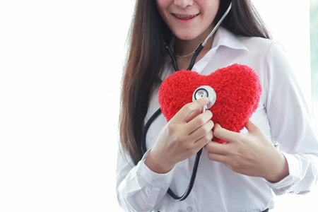 Female doctor use stethoscope listen heart shape.の写真素材