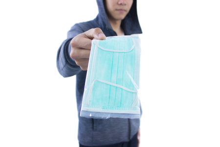 Man holding surgical mask isolated on white background. Coronavirus concept.