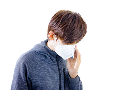 Boy with a medical mask on his face, isolated on white background