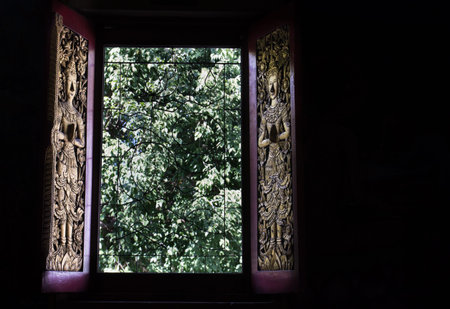 gold angel sculpture on opening temple window