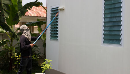 worker holding roller painting wallのeditorial素材