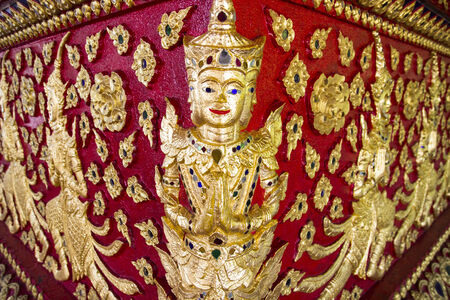 asian angel sculpture paying respect to buddhaの写真素材