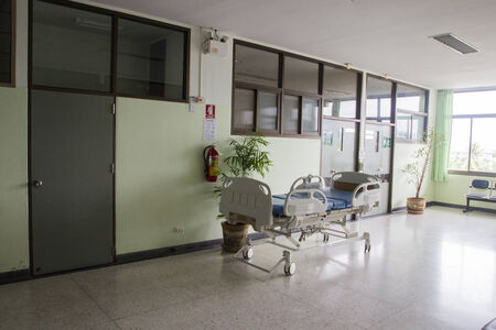 empty bed in front of patient room in hospital corridorのeditorial素材