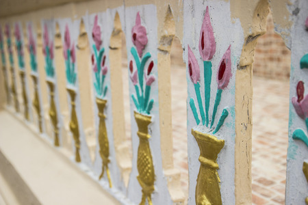 flower in vase sculpture on banister pattern backgroundの写真素材