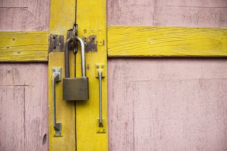 padlock on old grunge pink wooden doorの写真素材