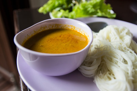 fermented rice noodle eaten with spicy minced fish soup and lettuce