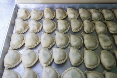 curry puff dough in a tray waiting for fryingの写真素材